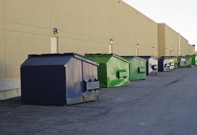 a construction worker moves construction materials near a dumpster in Belle Glade FL